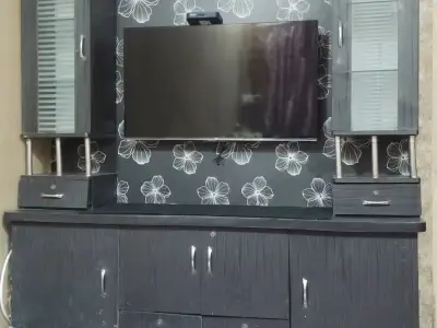 Black Entertainment TV Unit with White Floral Backing, Glass Cabinets & Ample Storage. Black Entertainment TV Unit with White Floral Backing, Glass Cabinets & Ample Storage.